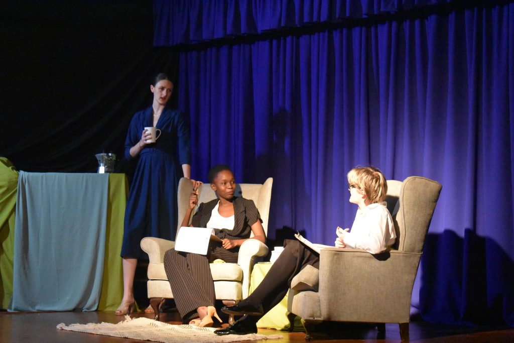 Actors in armchairs on the Top Girls set