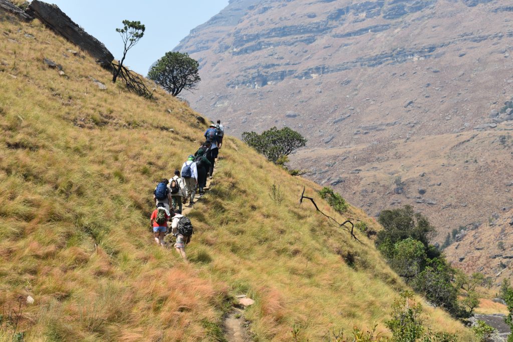 Students climbing a steep mountain path