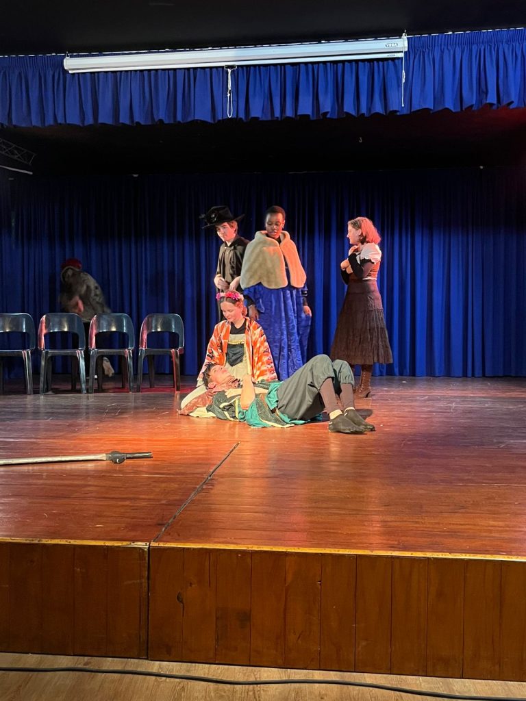 The Wyrd Sisters cast on stage