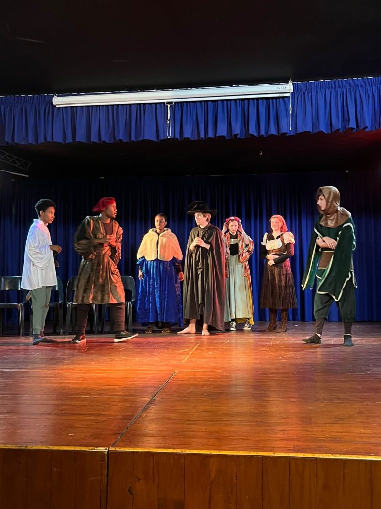 The cast of the Class 12 play on stage in costume