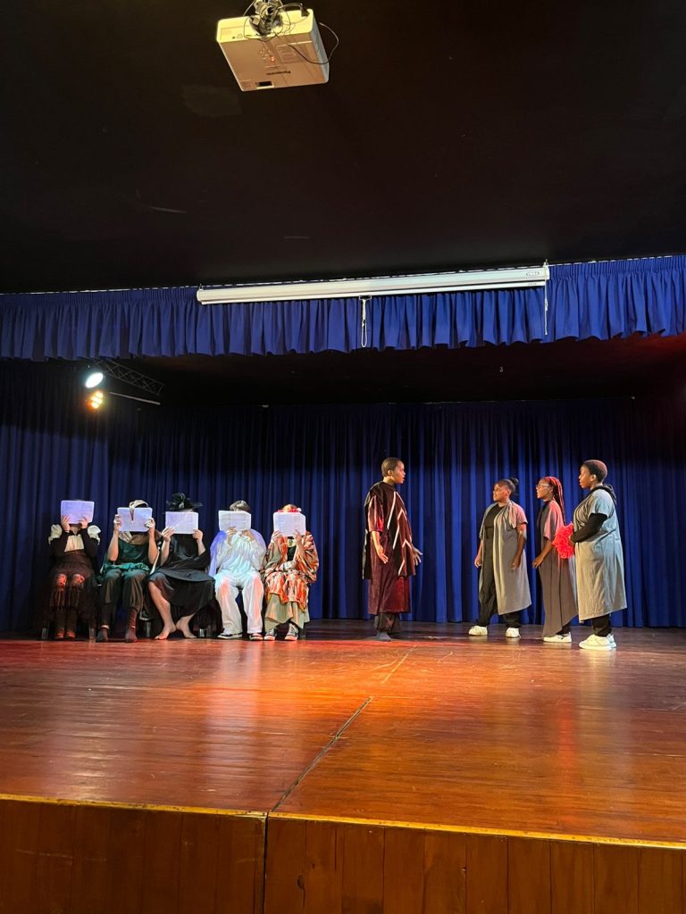 Students in costume on stage during a school play