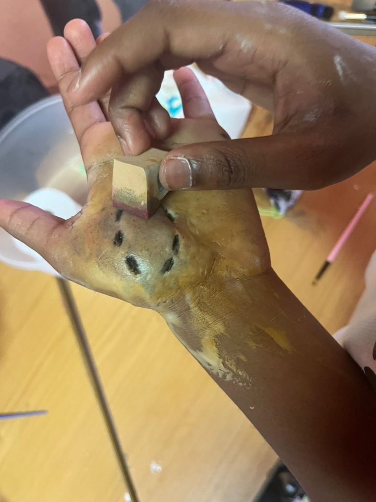 A realistic wound sculpted on a hand with special effects make-up