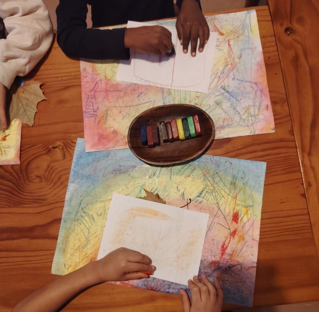 Children drawing with block crayons