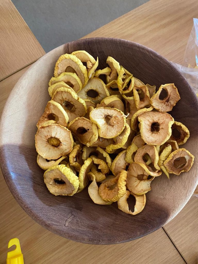 Home-made dried apple rings in a wooden bowl