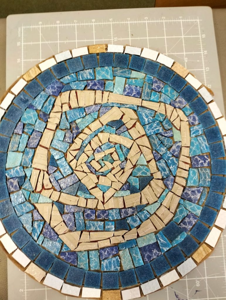 The Roseway rose laid in blue mosaic tiles
