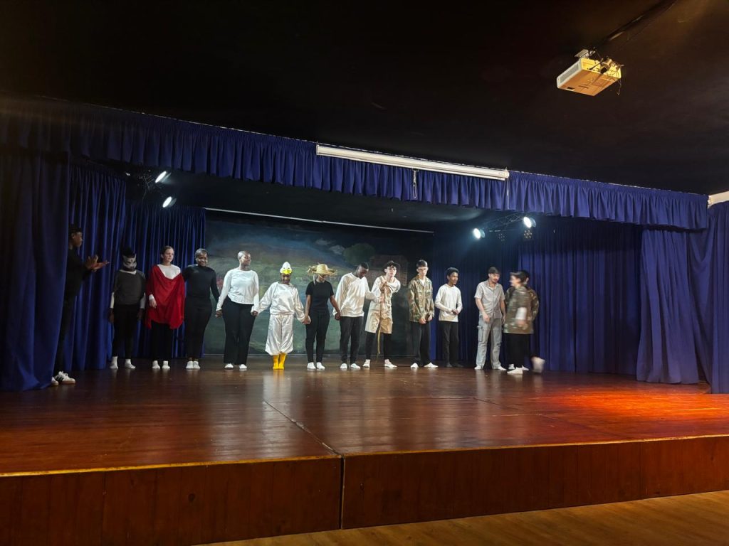 A High School class taking a bow on the school hall stage